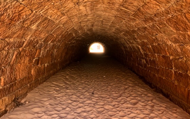 Diagram showing Kafka source feeding into Spark Structured Streaming with checkpoint tracking, flowing into Delta Lake transaction log for exactly-once writes